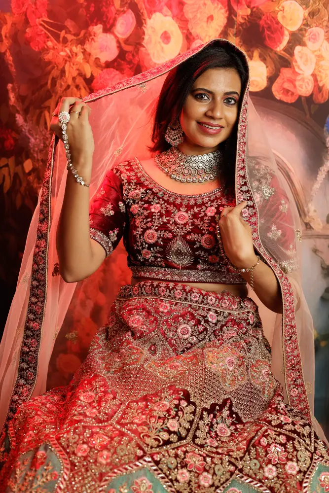 Elegant red bridal lehenga with heavy zari embroidery and flared dupatta for wedding day.